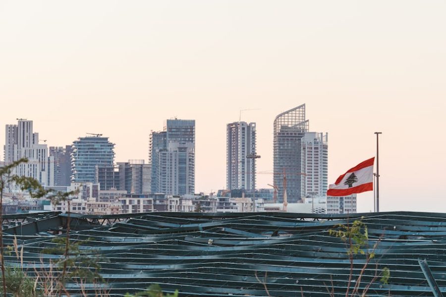 Captured view of Beirut's skyline with the Lebanese flag during sunset, showcasing urban architecture.